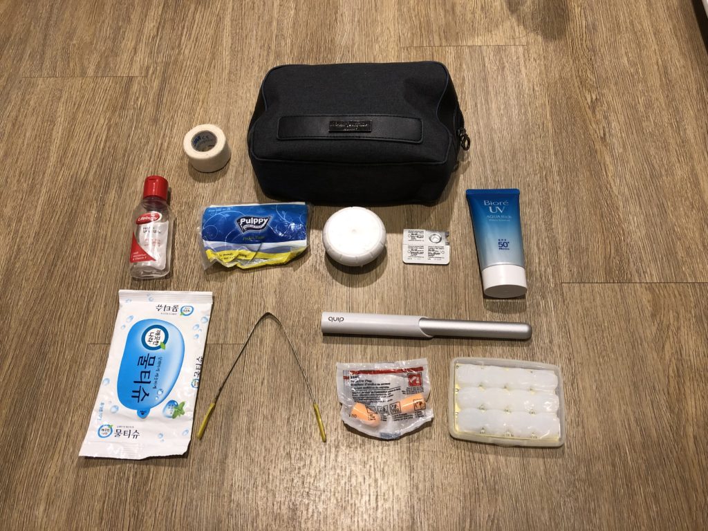 Toiletries, including hand sanitiser, tape, tissues, deodorant, sunscreen, imodium, toothbrush, earplugs, tongue scraper and bag.