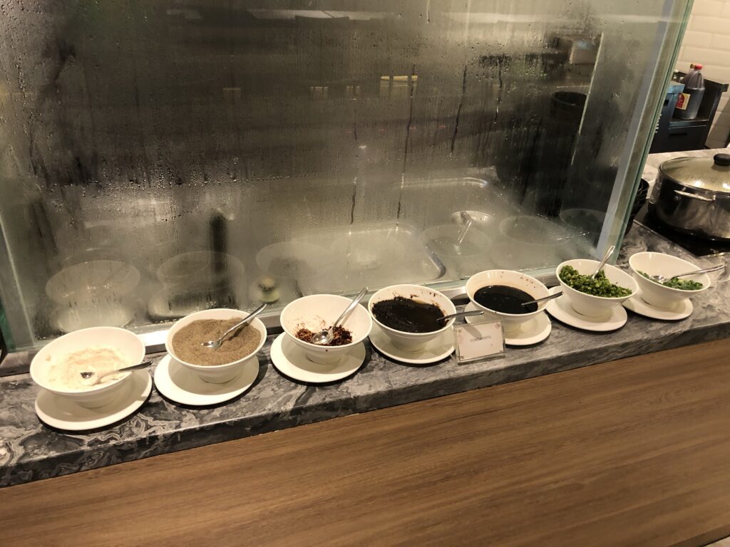 Noodle bar with plenty of condiments to choose from.